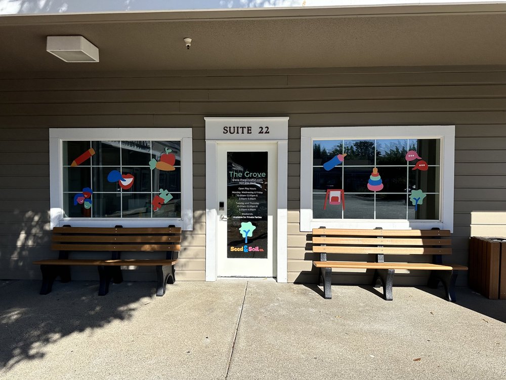The Grove entrance at Suite 22 with colorful window decorations and benches