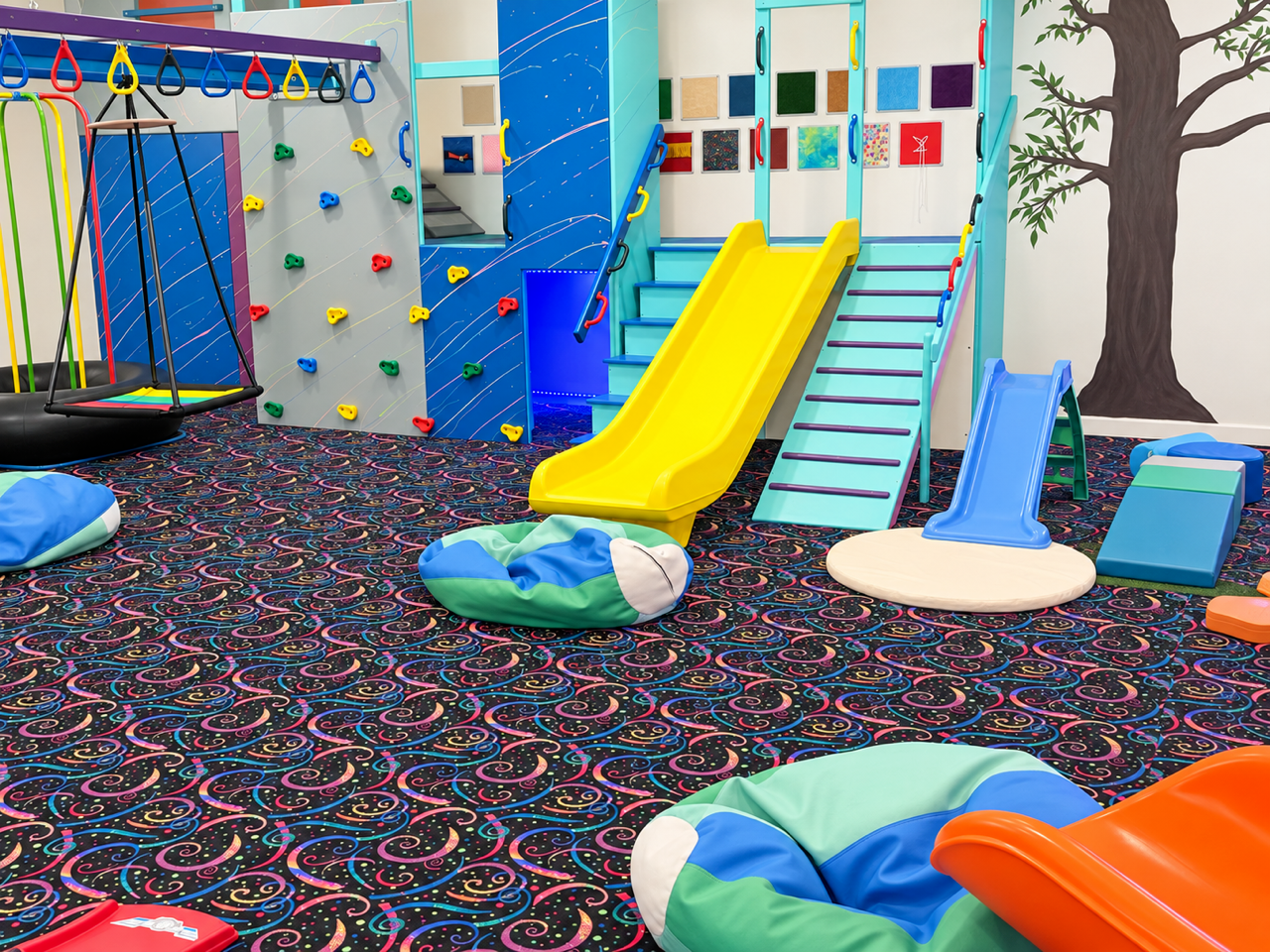 Colorful slides, climbing walls, swings and soft cushions in The Grove play gym